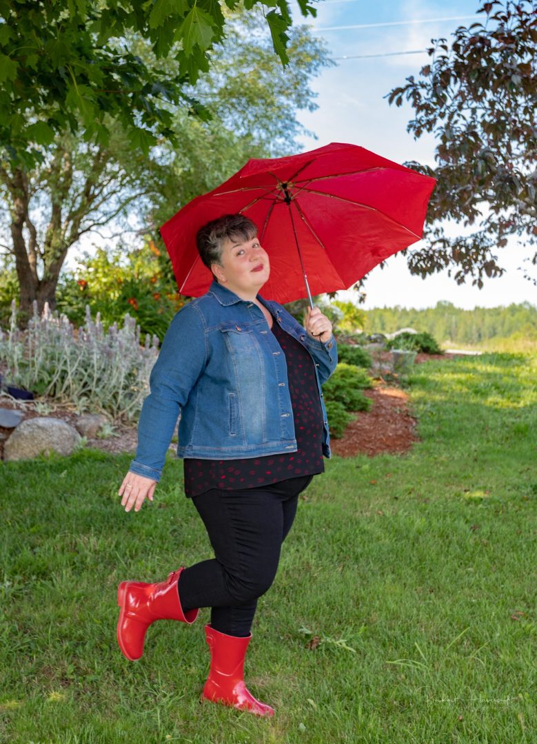 Bernice Williams showing her goofy side in her Red rubber boots and a red umbrella