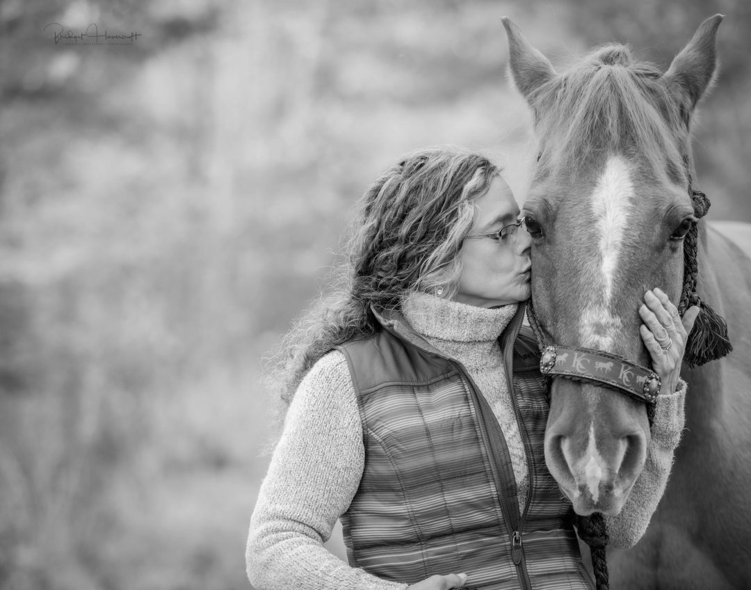 Sheree Prall showing her absolute devotion to one of her horses